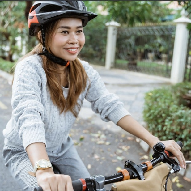 Woman in helmet riding bicycle