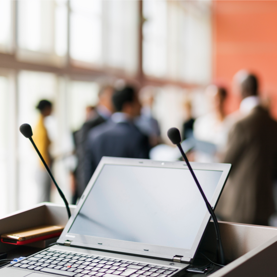 Laptop on lectern with two microphones