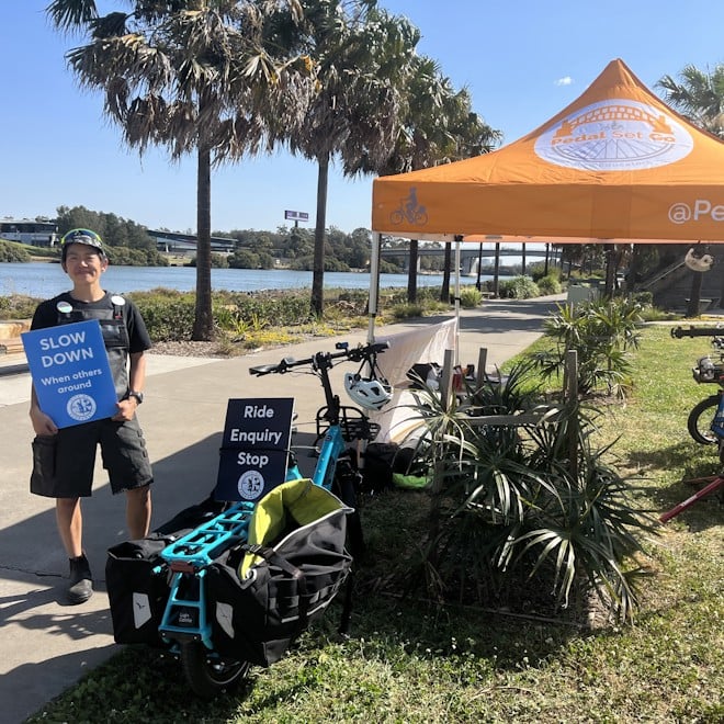 Pedal Set Go set up along Parramatta river with orange pop up tent