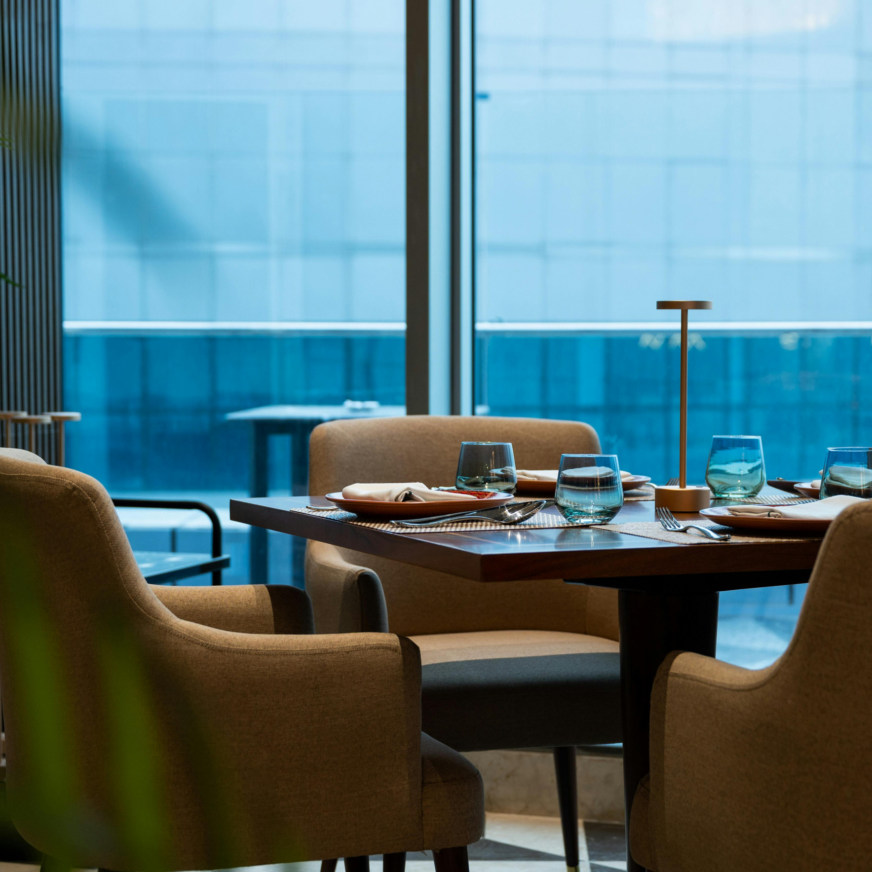 A man and woman jogging on a wooded path, smiling and talking. They wear athletic gear, conveying a sense of joy and camaraderie in a natural setting.