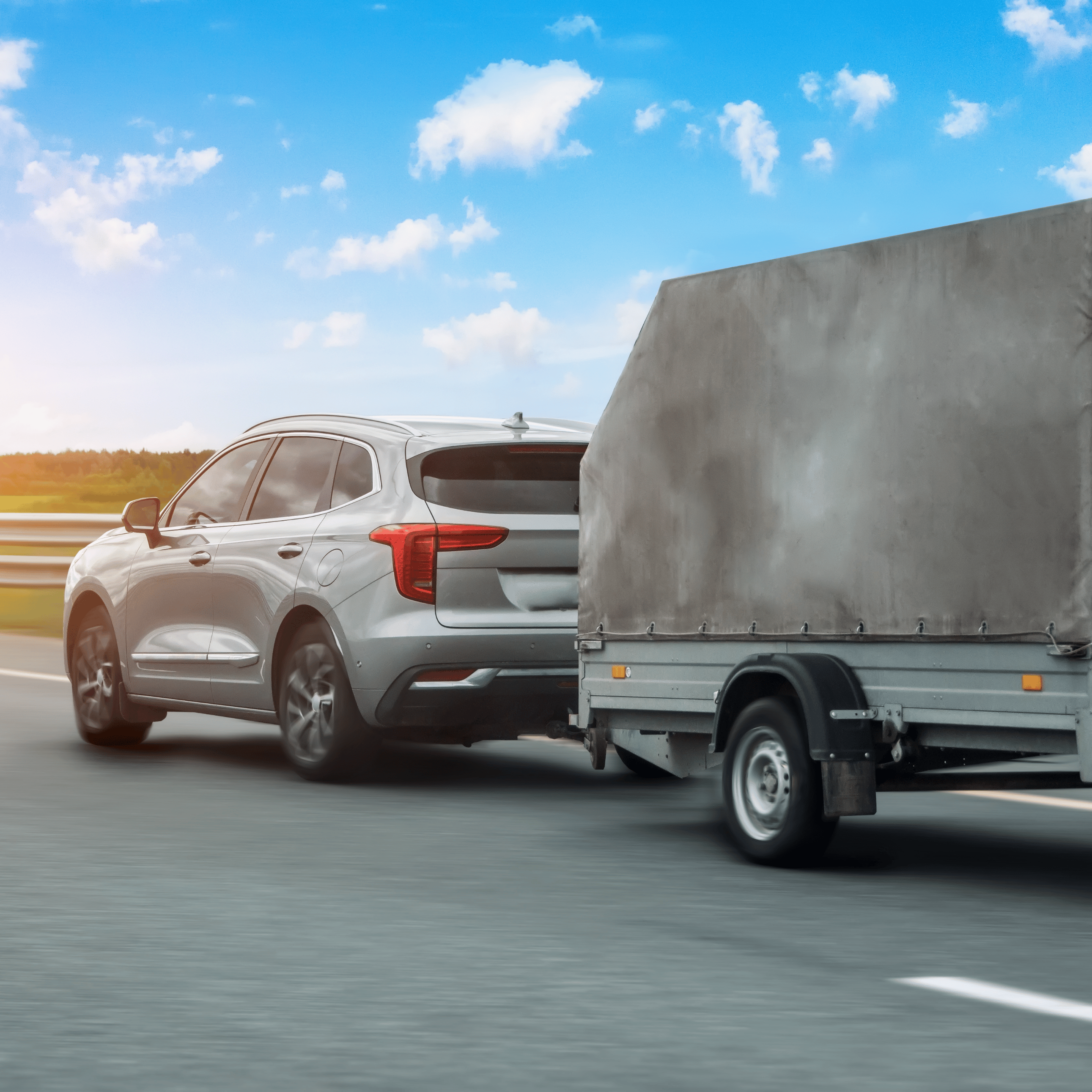 Grey 4WD towing trailer with cover