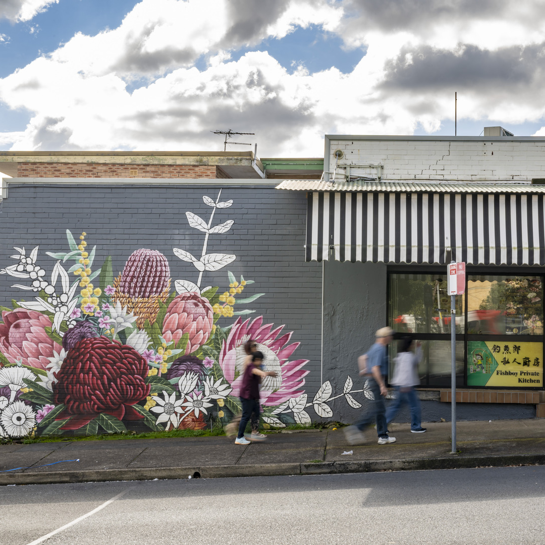 Shop facade in Telopea, grey background with colourful painted native flowers